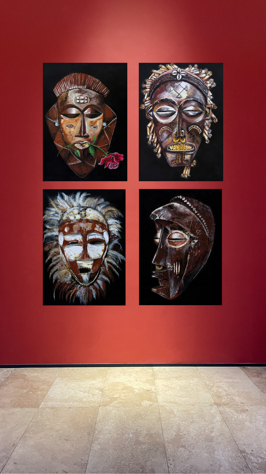 set of four traditional African masks with a black backround displayed in an art gallery